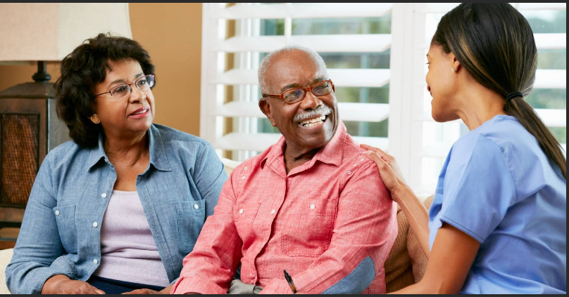 Home Health Aide and an aged man and woman